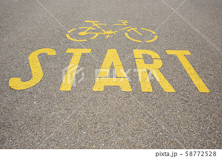 Bicycle road yellow paint start sign on asphalt 58772528