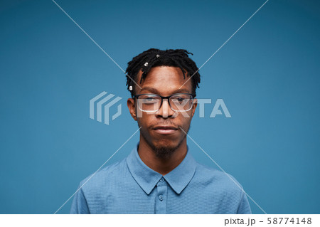 Contemporary African Man Posing on Blue Contemporary African Man Posing on Blue 58774148