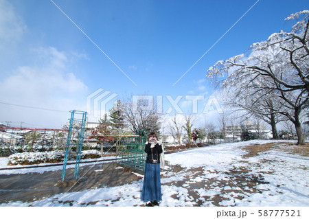雪の公園と女性 58777521