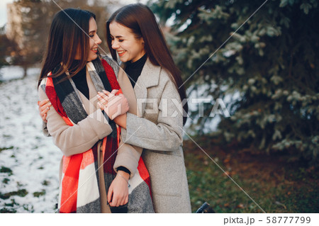 Two stylish girls have a rest in a city 58777799