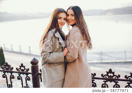 Two stylish girls have a rest in a city Two stylish girls have a rest in a city 58777971
