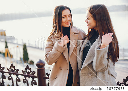 Two stylish girls have a rest in a city Two stylish girls have a rest in a city 58777973