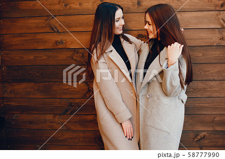 Two stylish girls have a rest in a city Two stylish girls have a rest in a city 58777990
