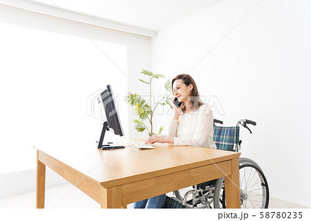 車椅子でデスクワークをする外国人の女性 58780235