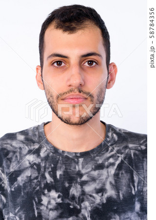 Face of young bearded Persian man looking at camera 58784356