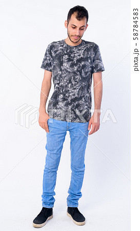 Full body shot of young bearded Persian man looking down Full body shot of young bearded Persian man looking down 58784583