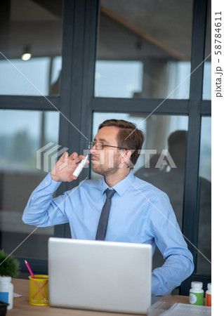 Businessman wearing glasses feeling bad having stuffy nose Businessman wearing glasses feeling bad having stuffy nose 58784611