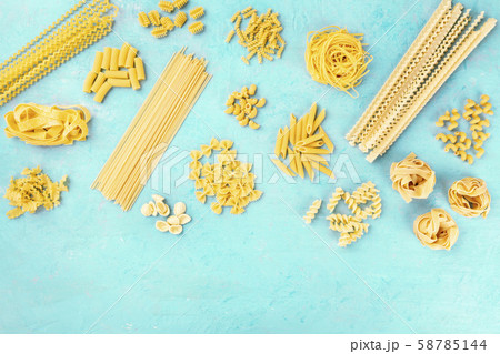 Italian pasta variety, flat lay banner, shot from the top on a blue background with a place for text 58785144