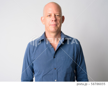 Face of mature handsome bald businessman looking at camera Face of mature handsome bald businessman looking at camera 58786035