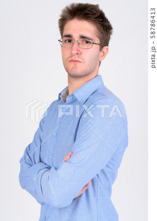 Young handsome businessman wearing eyeglasses with arms crossed 58786413