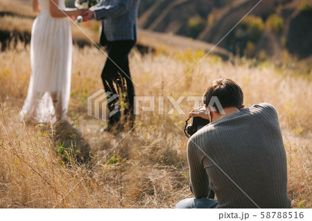 wedding photographer takes pictures of the bride and groom 58788516