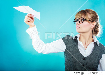 Fly fear. Woman holding airplane in hand. 58789463
