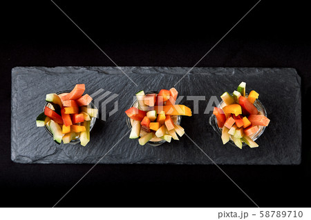 Delicious juicy cucumbers, carrots, celery, cut into thin strips or clubs, are served in a glass Delicious juicy cucumbers, carrots, celery, cut into thin strips or clubs, are served in a glass 58789710