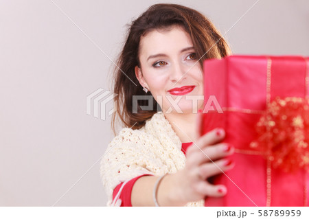 Woman with red christmas gift box Woman with red christmas gift box 58789959