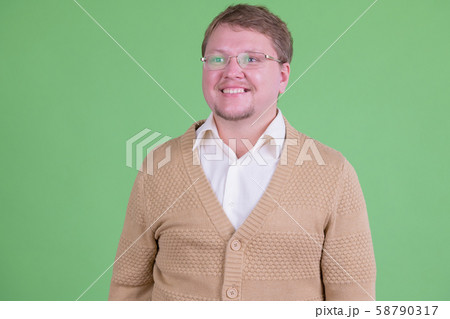 Portrait of happy overweight bearded man with eyeglasses thinking Portrait of happy overweight bearded man with eyeglasses thinking 58790317