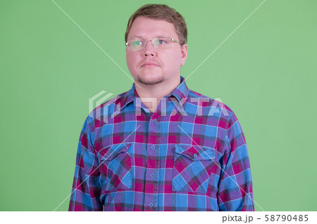 Overweight bearded hipster man with eyeglasses thinking Overweight bearded hipster man with eyeglasses thinking 58790485