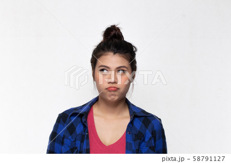 Asian girl with funny boring face over background. Asian girl with funny boring face over background. 58791127