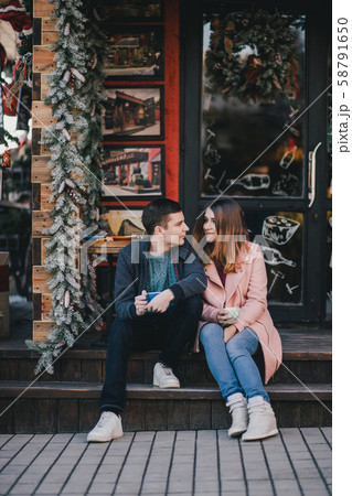 Happy couple drinking coffee on a Christmas market 58791650