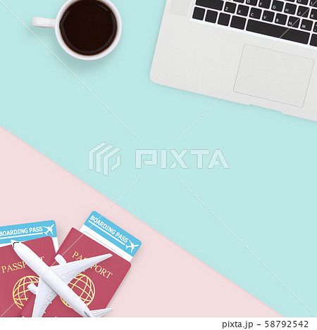 flat lay of passport , white plane model and computer laptop on pastel blue and pink color background with copy space. travel , visa and vacation concept 58792542