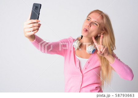 Young beautiful blonde woman taking selfie with peace sign Young beautiful blonde woman taking selfie with peace sign 58793663