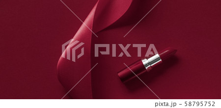 Luxury lipstick and silk ribbon on maroon holiday 58795752