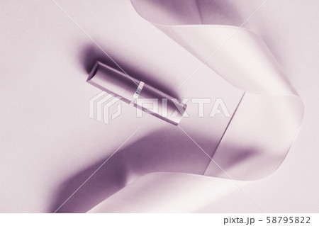 Luxury lipstick and silk ribbon on blush purple 58795822