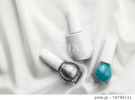 Nail polish bottles on silk background, french 58796131