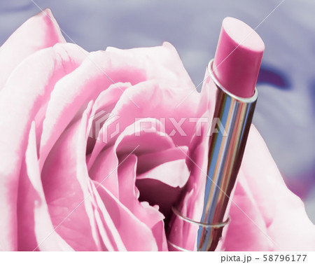 Pink lipstick and rose flower on liquid 58796177