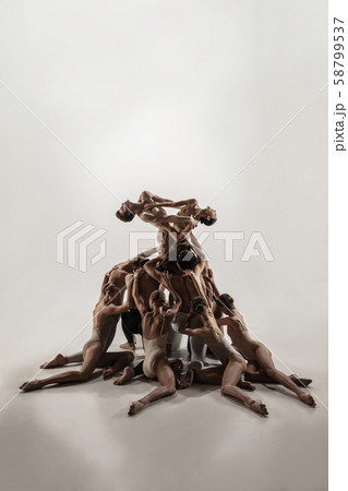 The group of modern ballet dancers. Contemporary art ballet. Young flexible athletic men and women. The group of modern ballet dancers. Contemporary art ballet. Young flexible athletic men and women. 58799537
