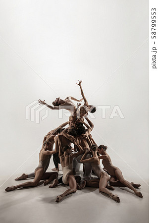 The group of modern ballet dancers. Contemporary art ballet. Young flexible athletic men and women. The group of modern ballet dancers. Contemporary art ballet. Young flexible athletic men and women. 58799553