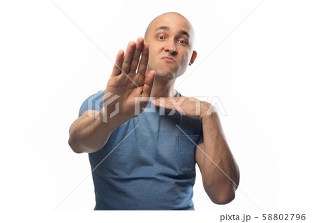 Photo of young shaved man on white telling no Photo of young shaved man on white telling no 58802796