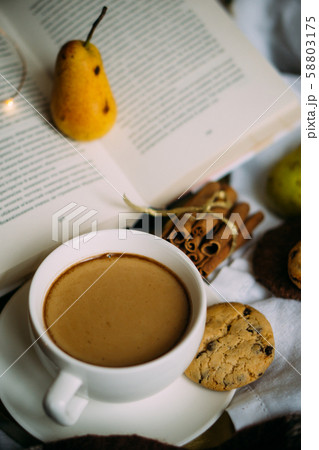 Cozy home weekend arrangement, warm bedroom decorations with coffee, wool blanket Cozy home weekend arrangement, warm bedroom decorations with coffee, wool blanket 58803175