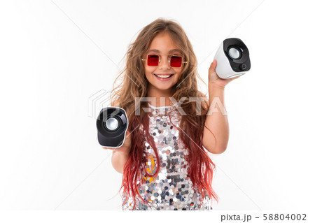 Teen girl with long blonde hair dyed with tips pink, in shiny light dress, black and white sneakers Teen girl with long blonde hair dyed with tips pink, in shiny light dress, black and white sneakers 58804002