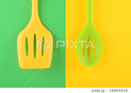 bright kitchen utensils on yellow and green background, creative idea bright kitchen utensils on yellow and green background, creative idea 58804816