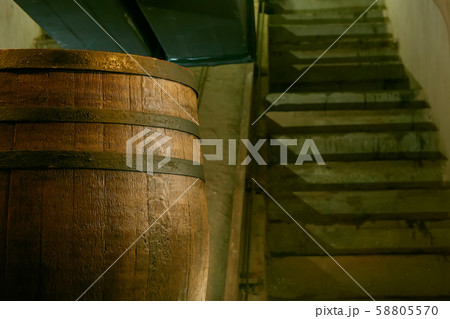 wooden barrel on a dark background, in a workshop, in an old room. production of barrels for cognac 58805570
