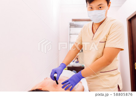 Therapist performing moxibustion procedure Therapist performing moxibustion procedure 58805876