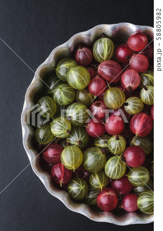 Gooseberries in a metal baking pan on a black background Gooseberries in a metal baking pan on a black background 58805982