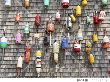 Lobster buoys on wall of building in Maine Lobster buoys on wall of building in Maine 58807625