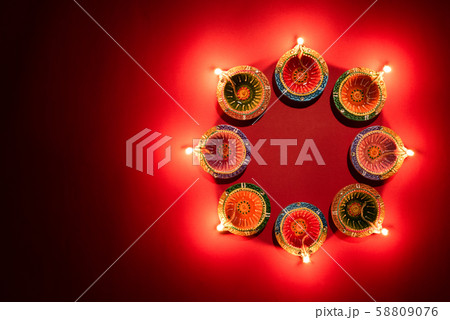 Happy Diwali - Clay Diya lamps lit during Hindu celebration 58809076