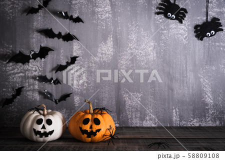 Halloween orange ghost pumpkins with witch hat on gray background Halloween orange ghost pumpkins with witch hat on gray background 58809108