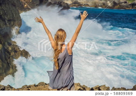 Woman traveler against the background of the sea Angel's Billabong in Nusa Penida, Bali, Indonesia Woman traveler against the background of the sea Angel's Billabong in Nusa Penida, Bali, Indonesia 58809369