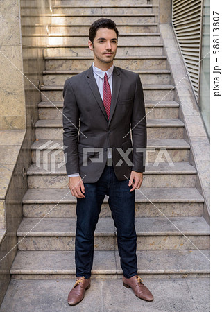 Portrait of young handsome businessman wearing suit in city Portrait of young handsome businessman wearing suit in city 58813807