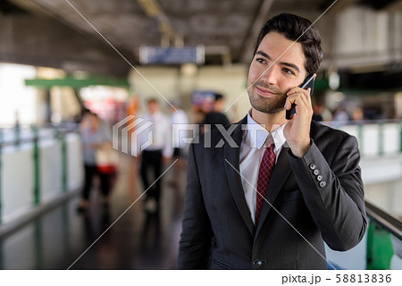 Portrait of businessman in city talking on mobile phone 58813836