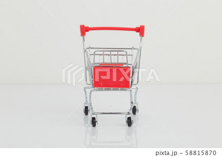 Miniature shopping cart and basket on white Miniature shopping cart and basket on white 58815870