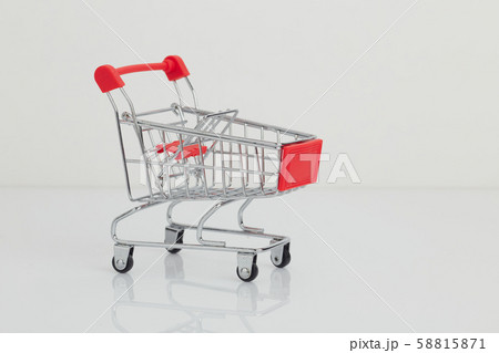 Miniature shopping cart and basket on white 58815871