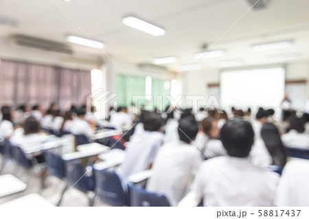 Blur school background back view university students writing answer doing exam in classroom 58817437