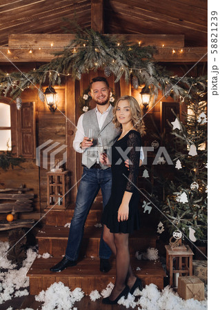 Beautiful couple with champagne under Christmas Beautiful couple with champagne under Christmas 58821239