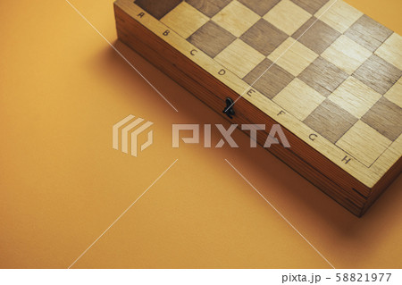 Beautiful old chess board on a orange background. Beautiful old chess board on a orange background. 58821977