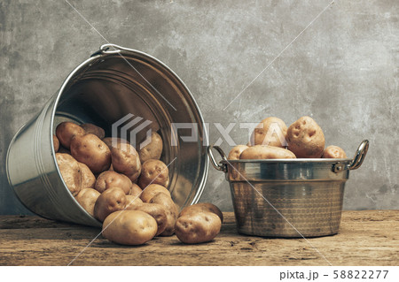 Fresh potatoes in silver basket on a old oak 58822277
