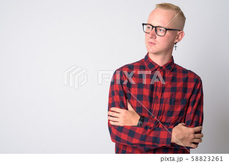 Portrait of young blonde hipster man thinking with arms crossed 58823261